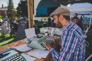 Gareth typing on an older typewriter during Cultivate Festival