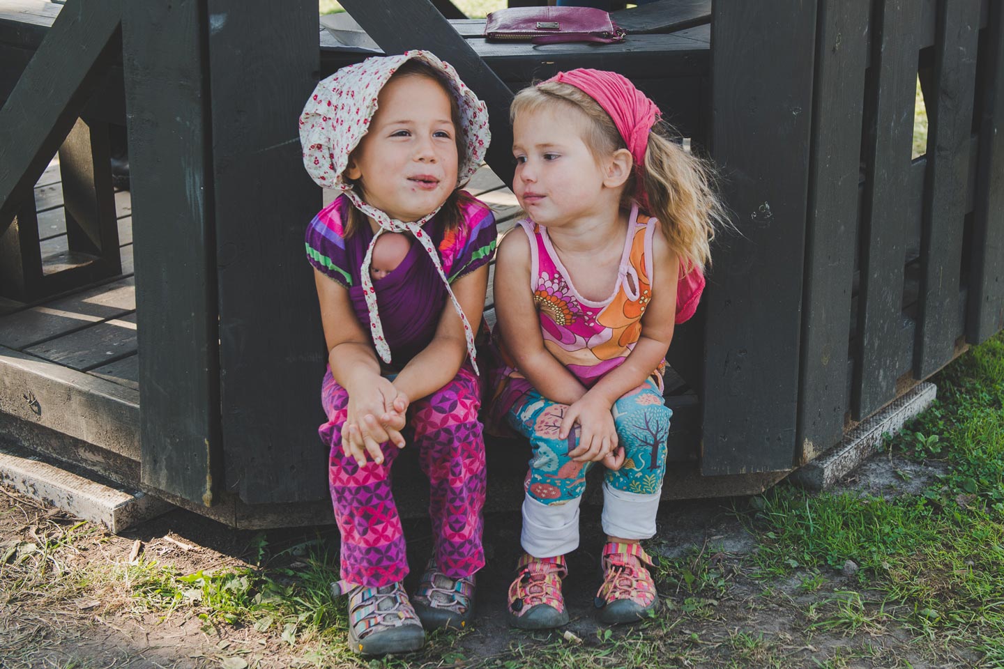 Little Girls Sitting Together Outside