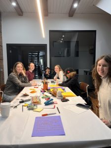 Cultivate: A Zine crew stting around a large table working on the first issue.