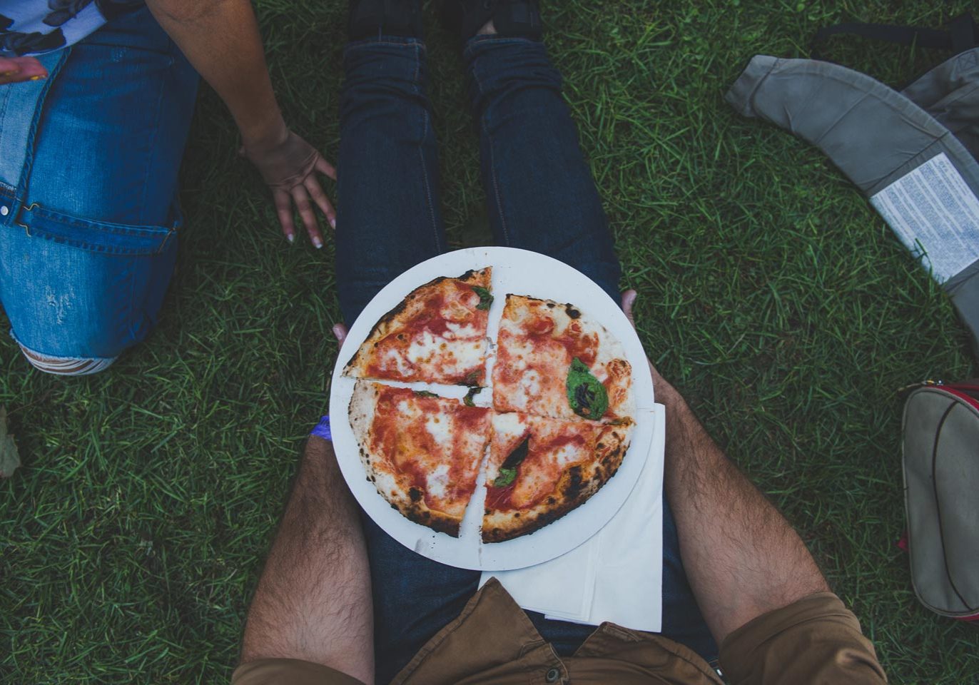 Attendee holds homemade pizza