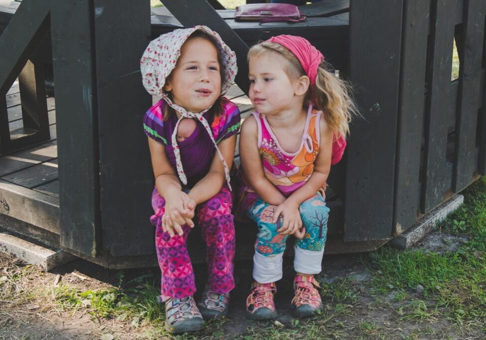 Little Girls Sitting Together Outside