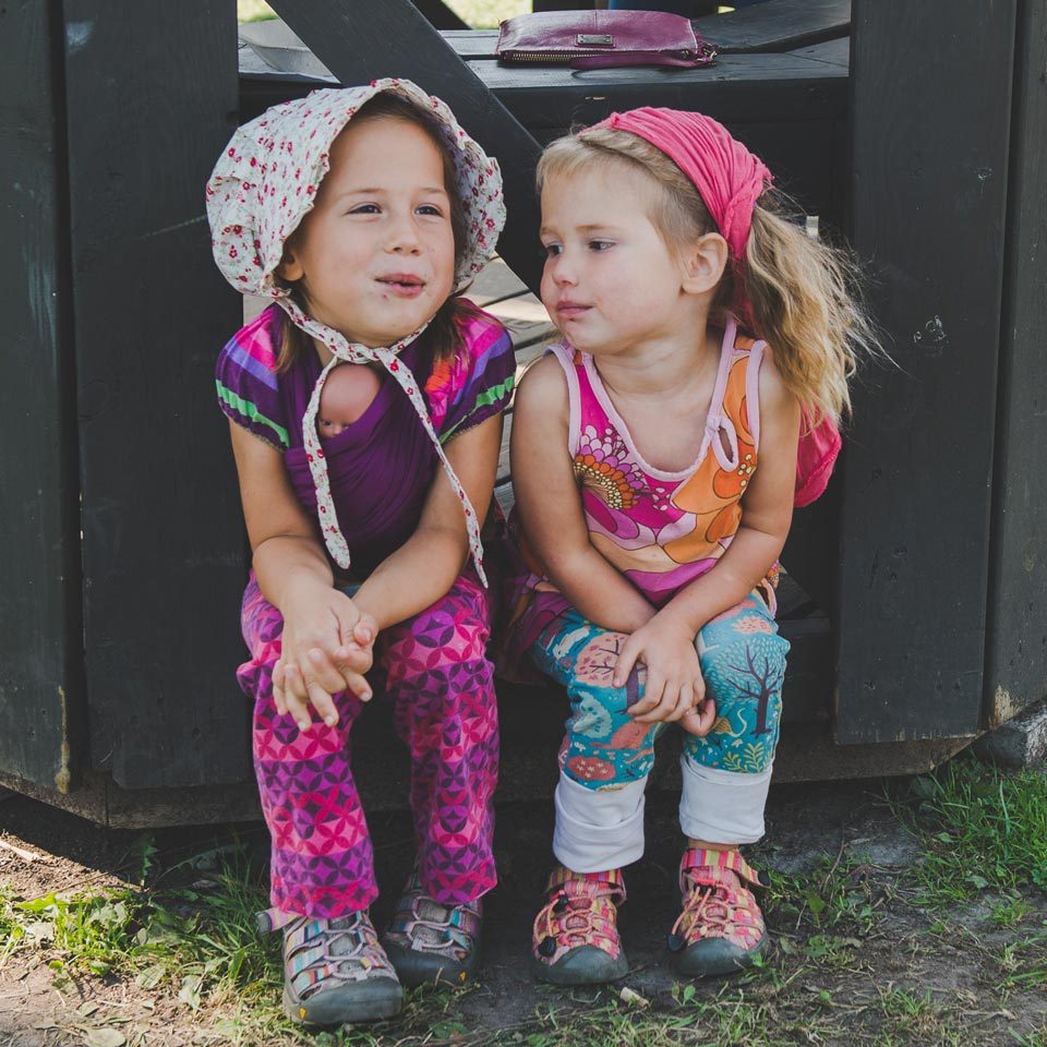 Little Girls Sitting Together Outside