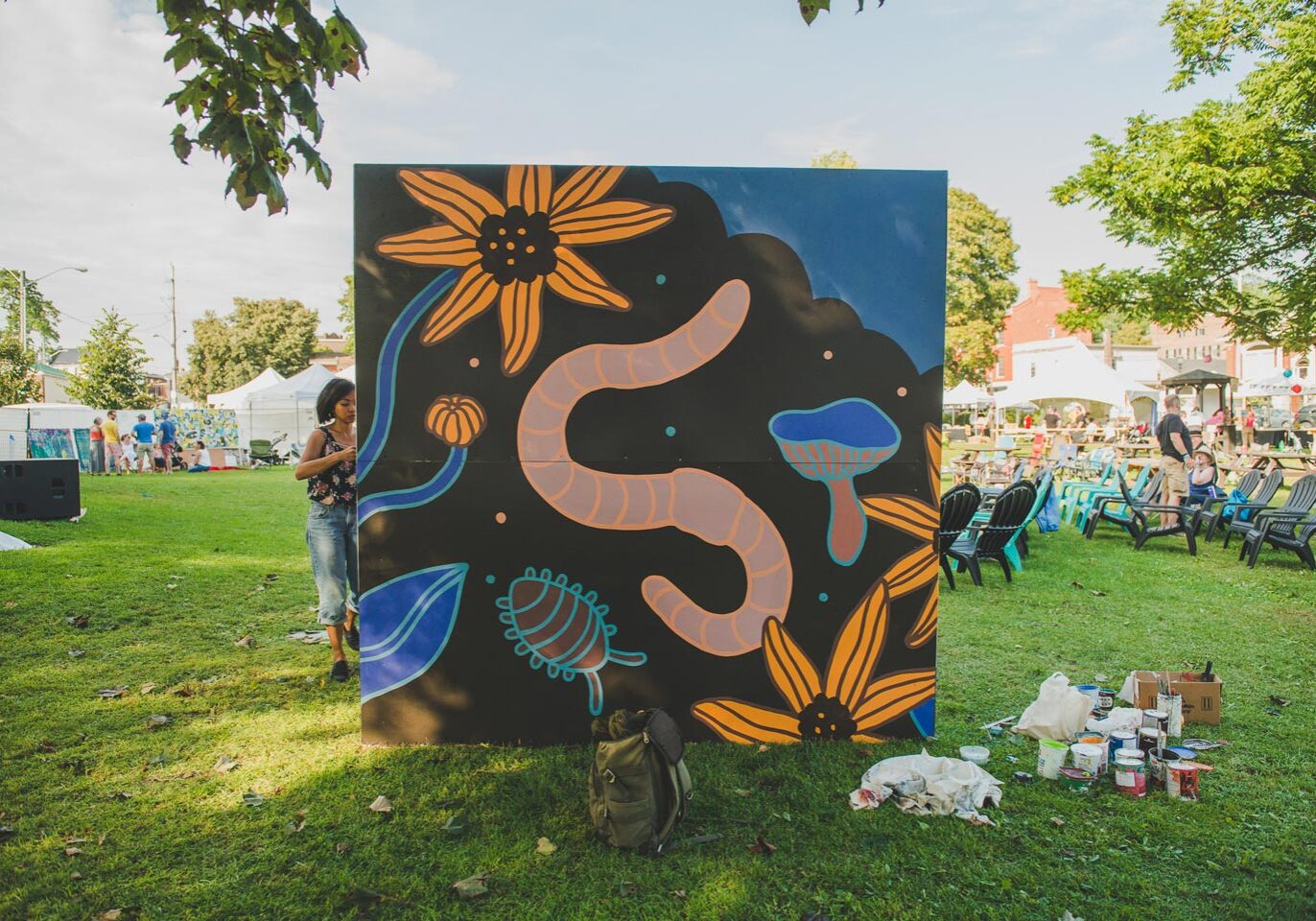 Painter stands with her large painting